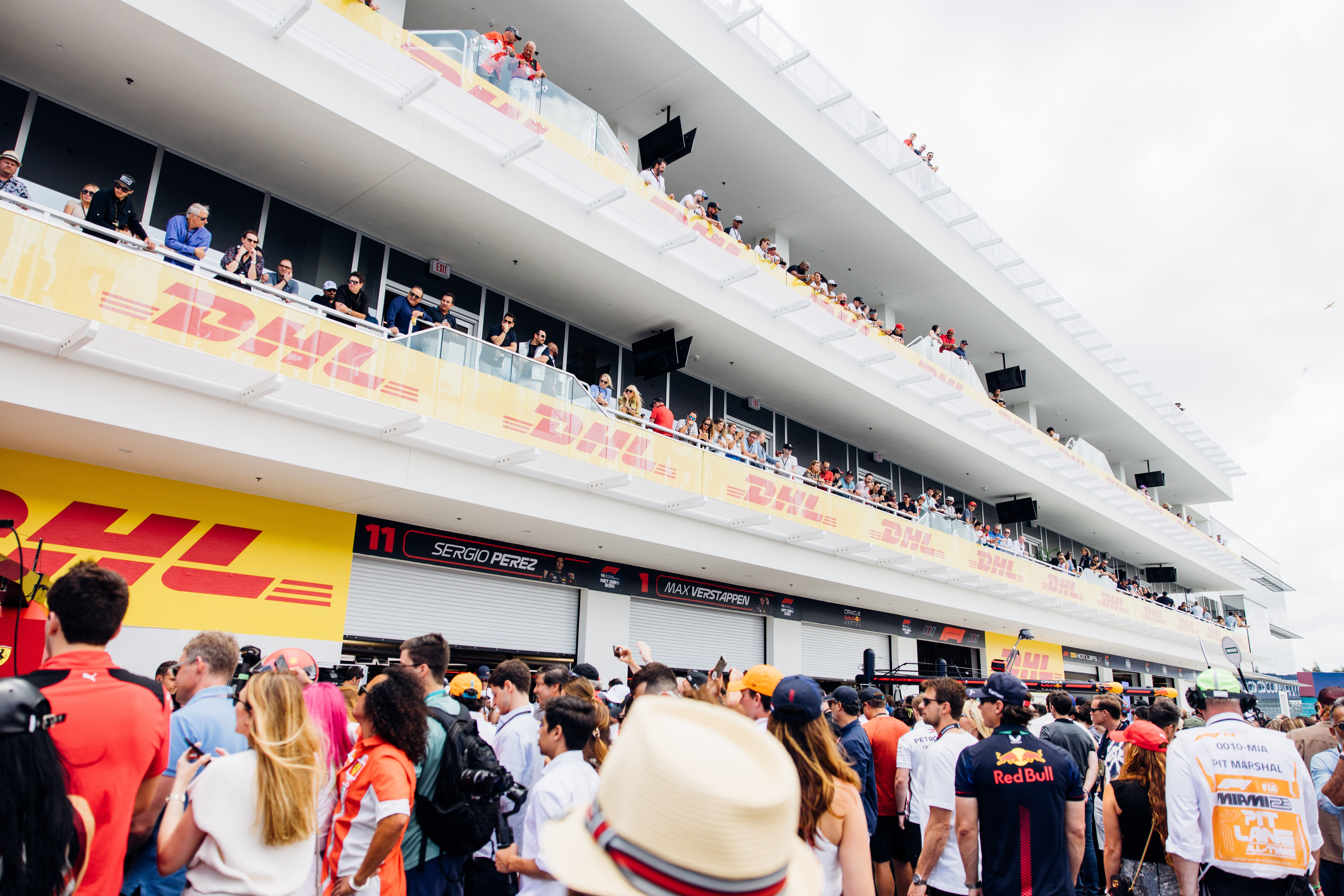 Formula 1 Miami Grand Prix event setup with spectators and team areas at Hard Rock Stadium